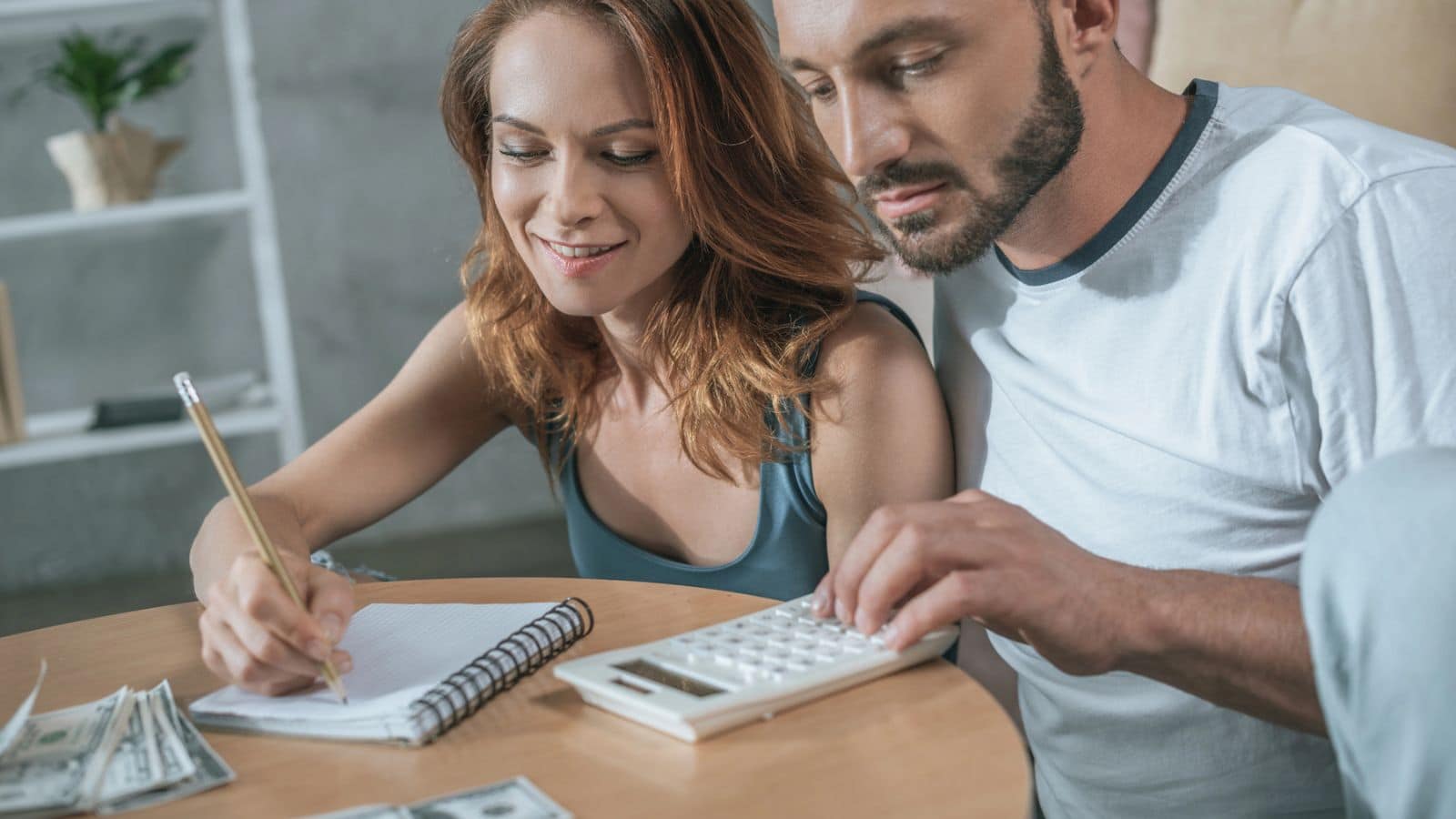 Couple sitting at table working on their budget
