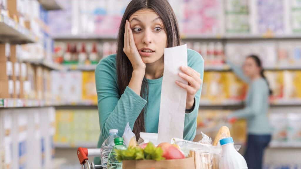 Woman upset when looking at her grocery receipt
