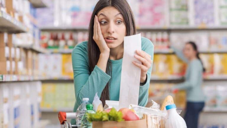 Woman upset when looking at her grocery receipt