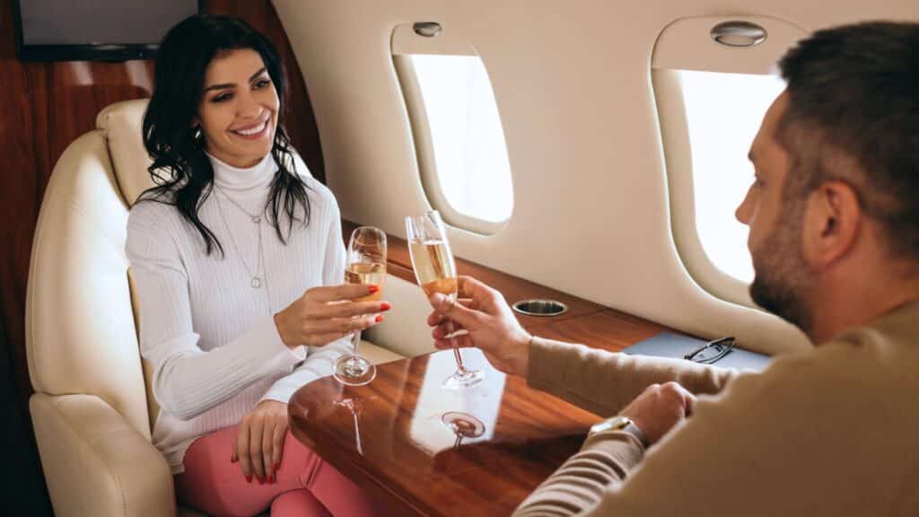 Couple drinking champagne on a private plane