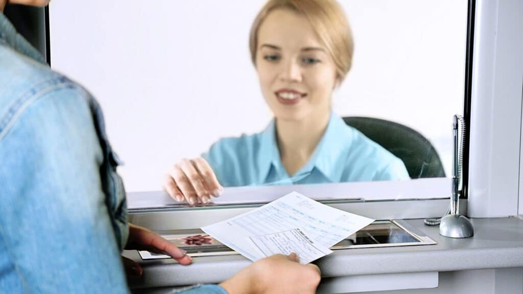 Bank teller waiting on customer