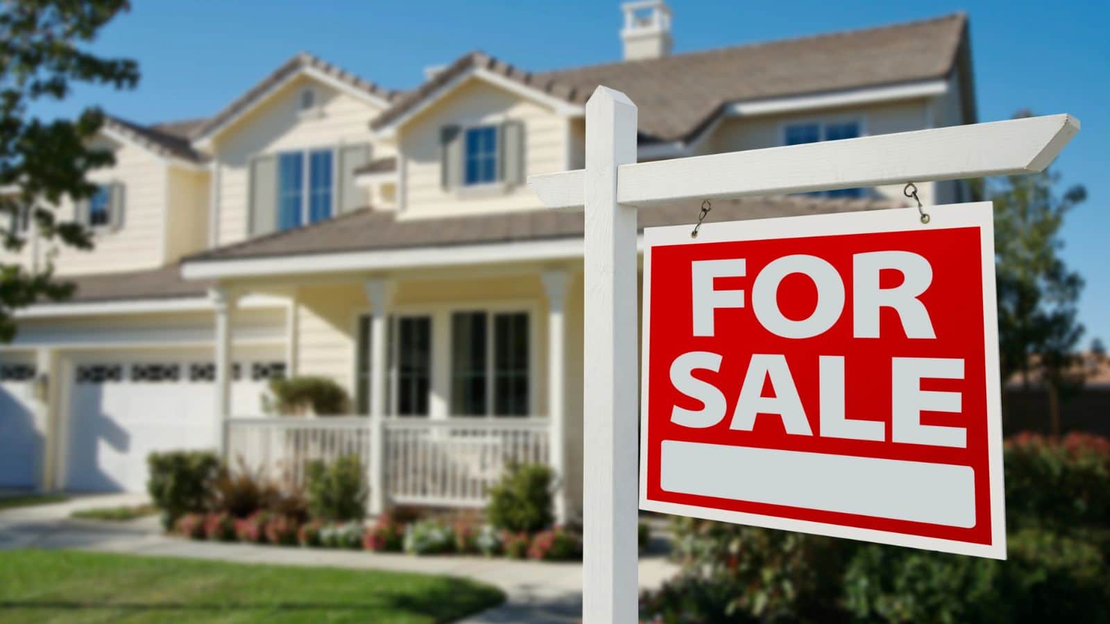 House with for sale sign in the yard