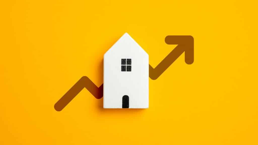Image of a white house on a yellow background with an arrow through it