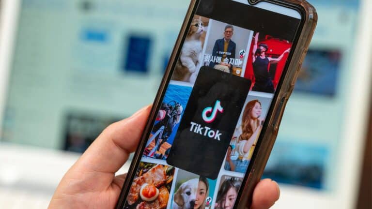 Person holding a smartphone with the tiktok logo