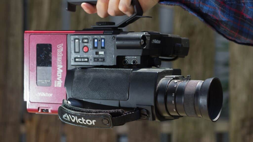 Person holding old school JCV Victor GRC1 camcorder