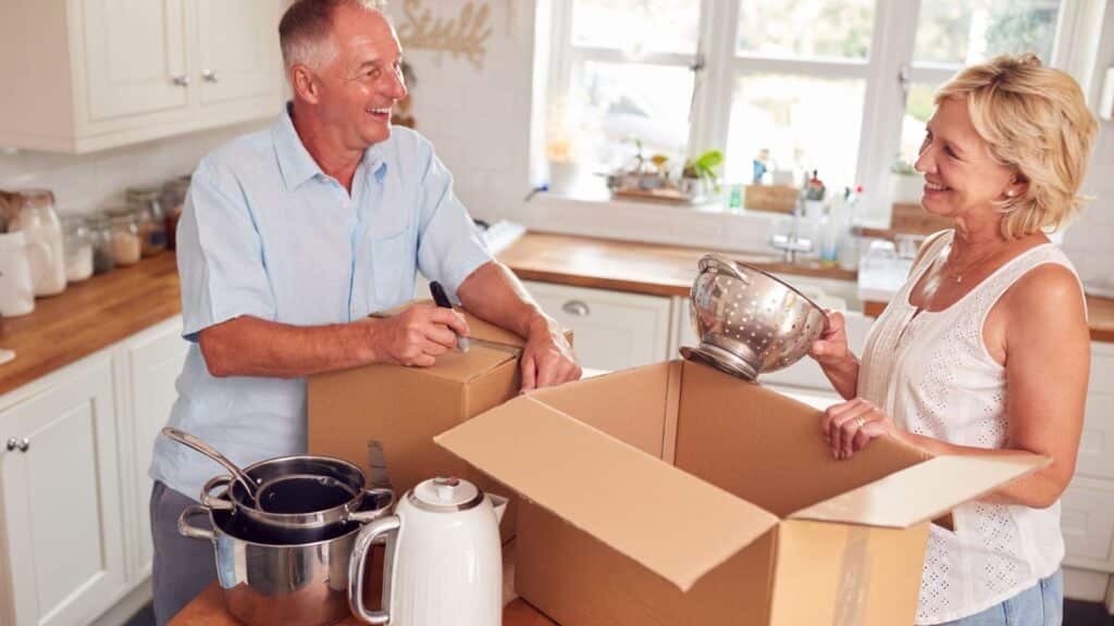 Elderly couple packing their house to downsize