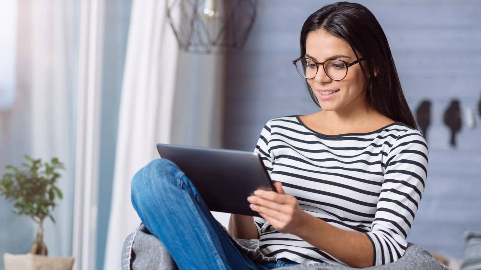 Young Gen Z woman working on her tablet