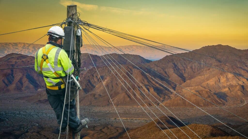 Lineworker doing work on a telephone pole