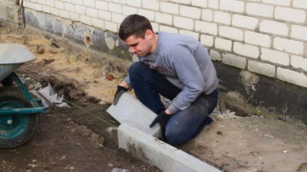 Man building something with cement blocks
