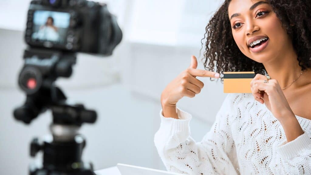 Young content creator filming a video about credit cards