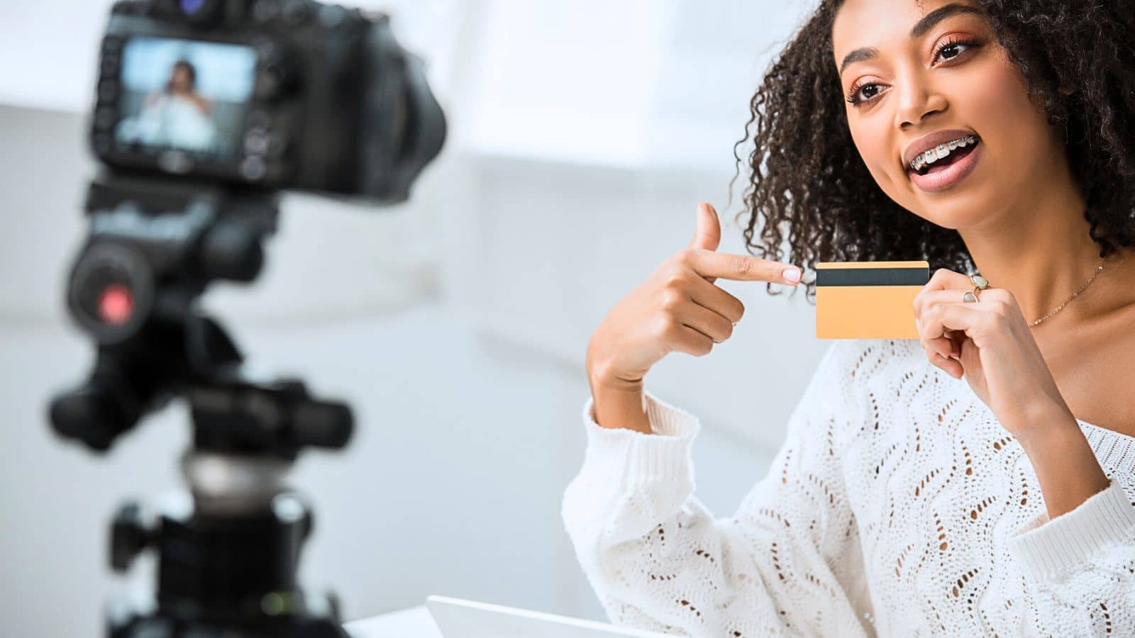 Young content creator filming a video about credit cards
