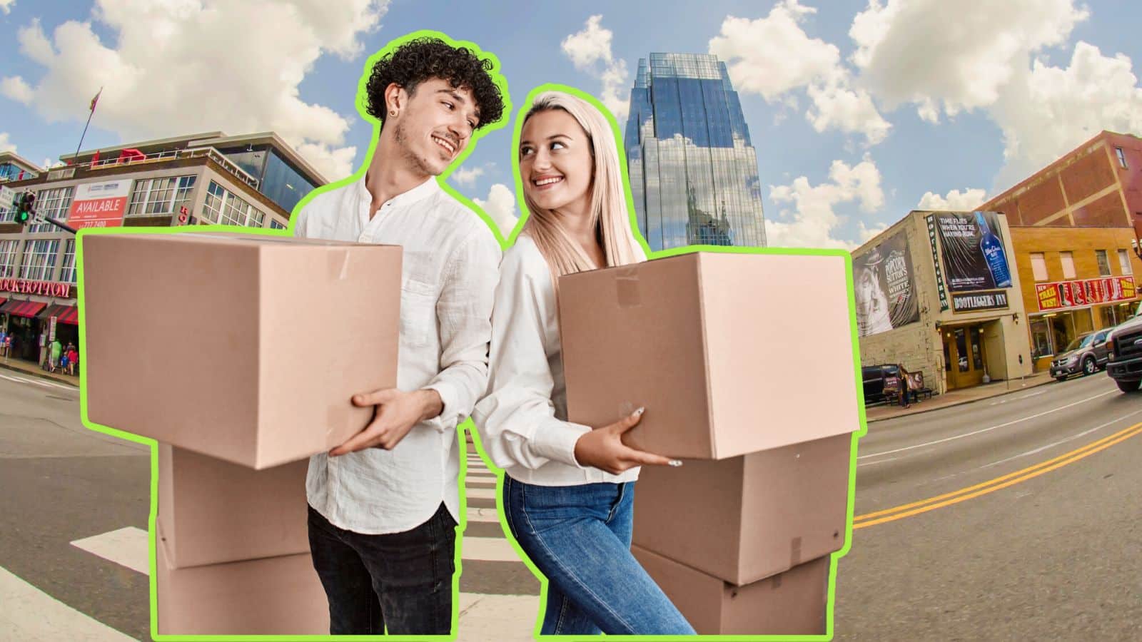 Wide shot of downtown Nashville, TN with couple holding moving boxes