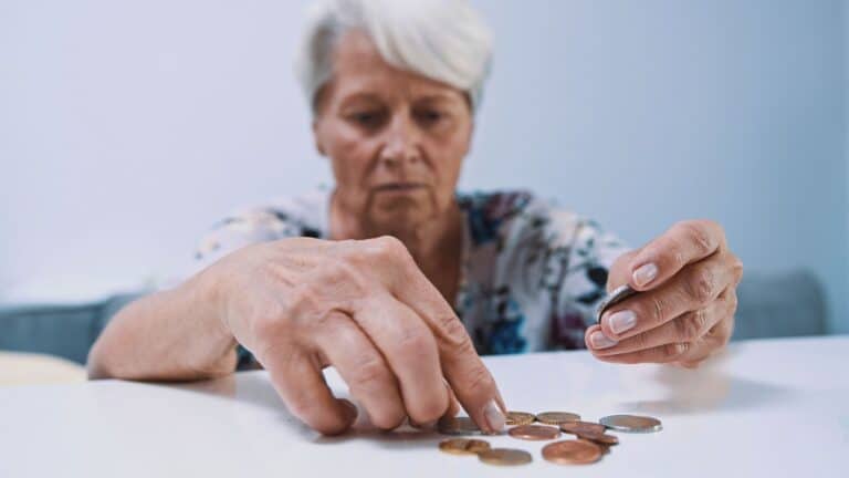 Old woman counting change at a table