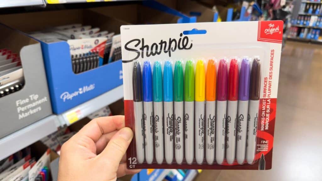 Person holding a pack of Sharpie markers in a store
