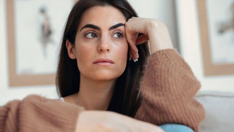 Woman sitting on the couch looking stressed