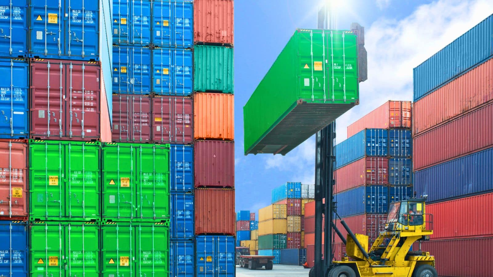 Forklift lifting up a rail car in a shipyard