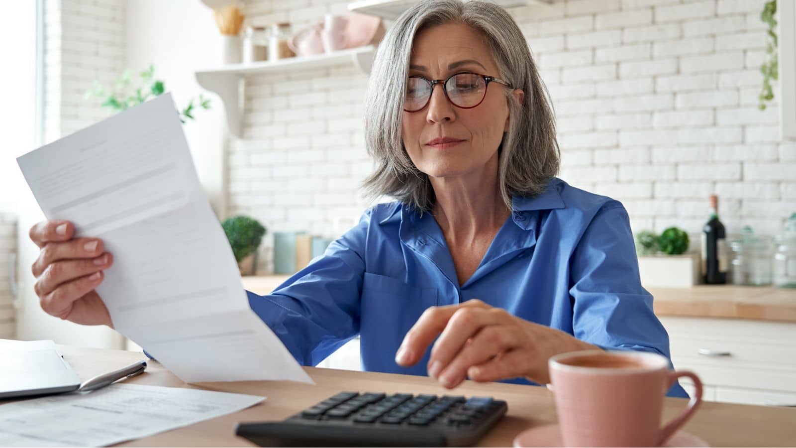 Mature woman paying bills