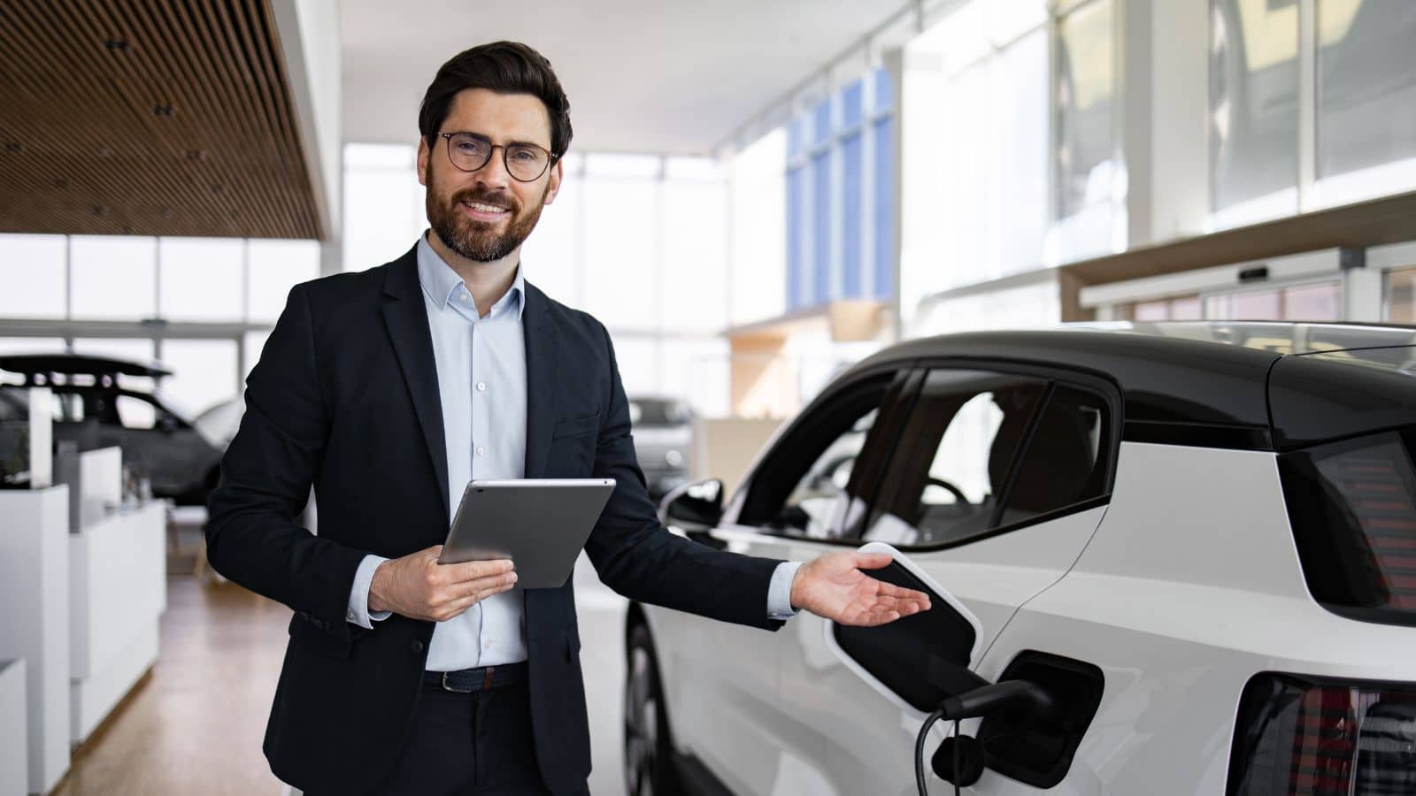 Car salesman showing an EV in the dealership