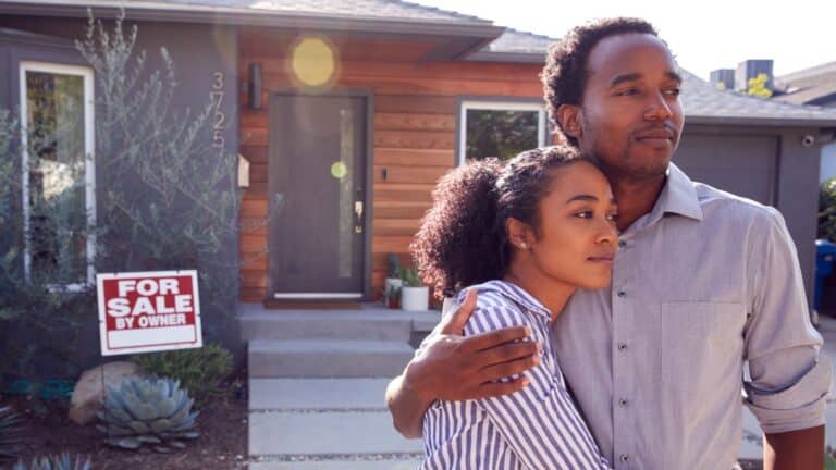 African American couple looking sad to sell their house