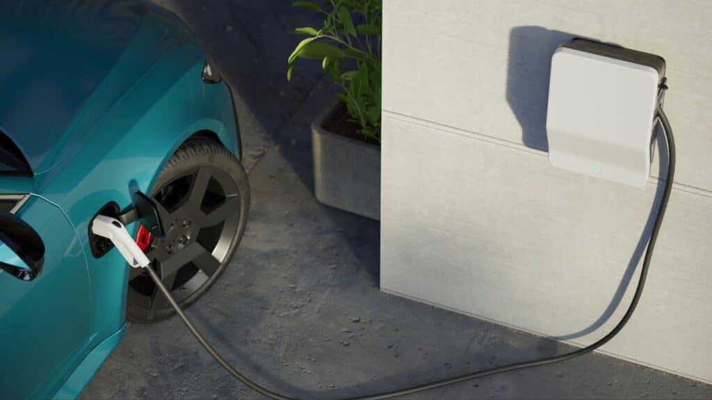Electric vehicle plugged into charger in garage