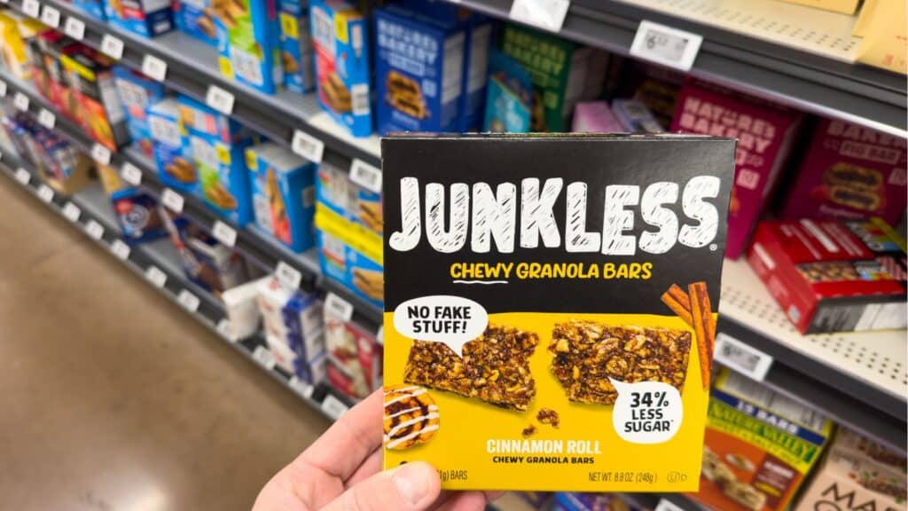 Person holding a bar ogf granola bars in the store