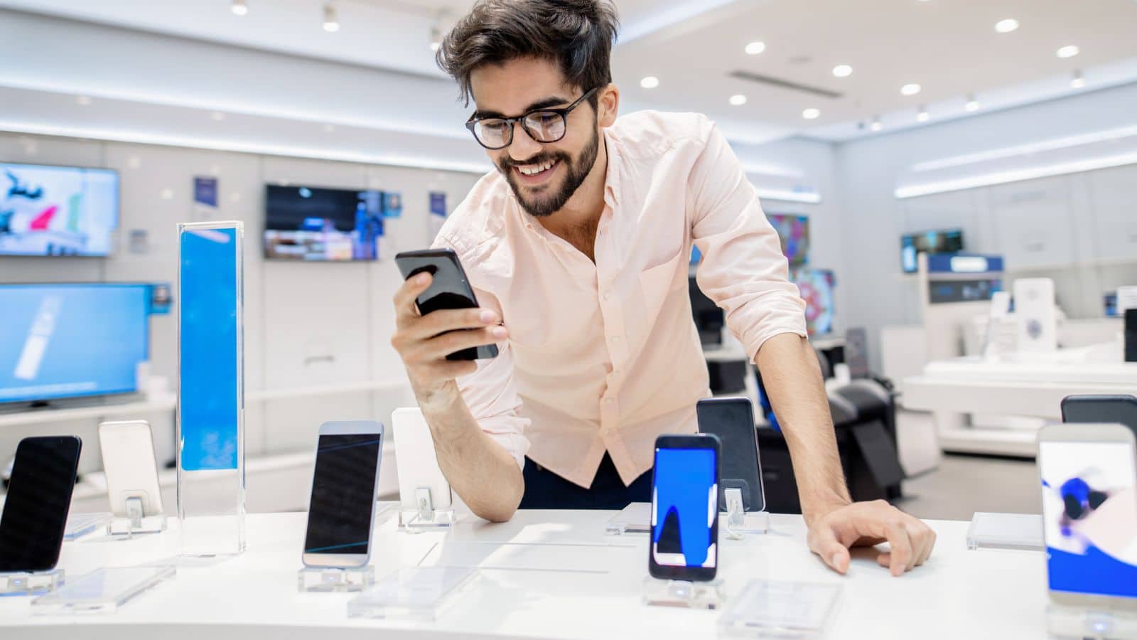 Man at store shopping for a new cell phone
