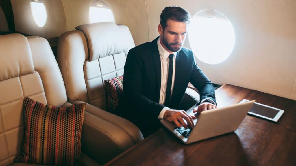 Wealthy man working while on a private plane