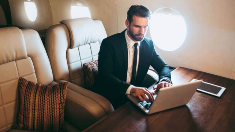 Wealthy man working while on a private plane