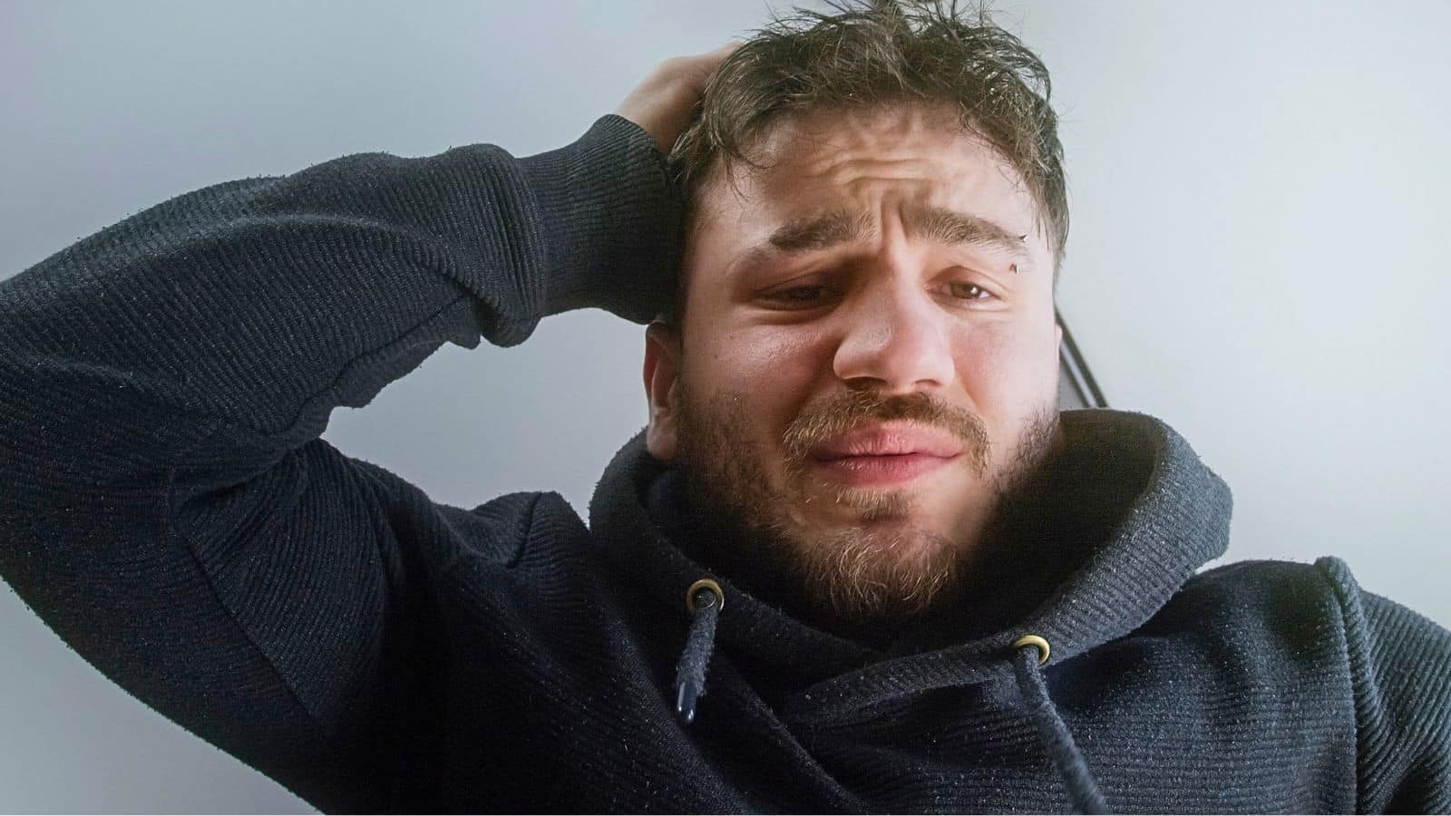 Man holding his head and looking like he's regretting something