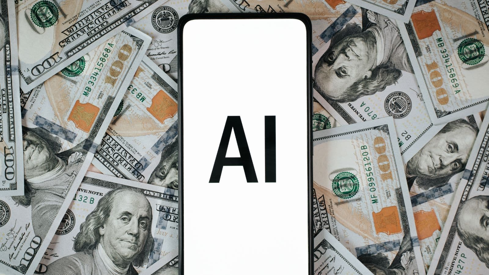 Cell phone with the letters AI on the screen with a background of cash