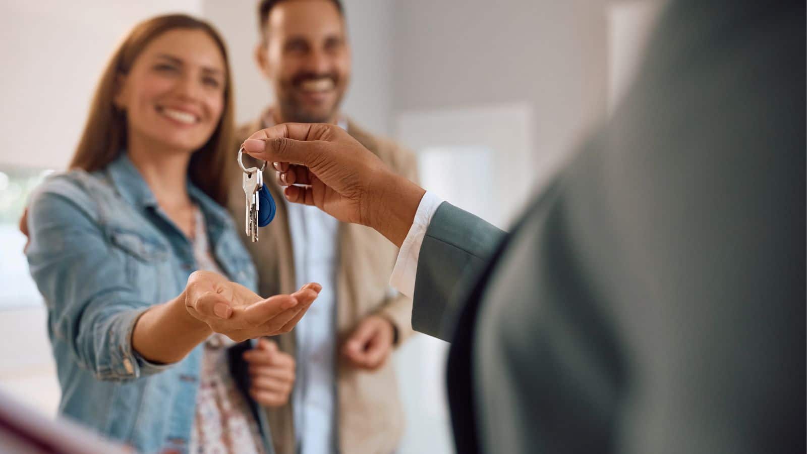 Happy couple receiving the keys to their new home