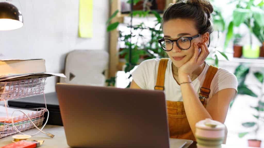 Young woman working remotely at her laptop