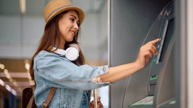 Young woman getting money at an ATM machine