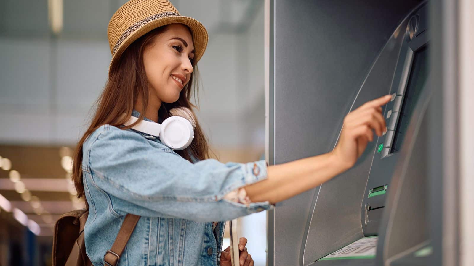 Young woman getting money at an ATM machine
