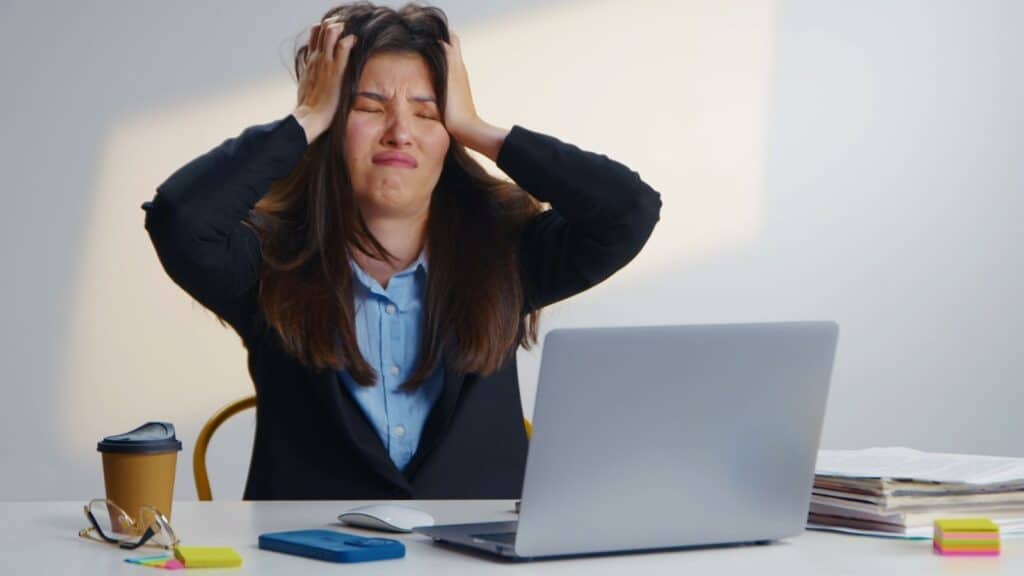 Woman sitting at her desk looking very frustrated