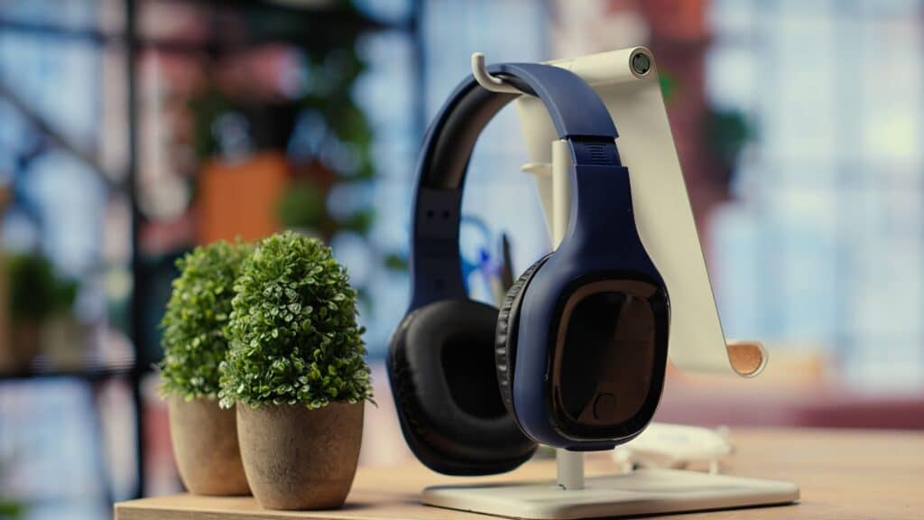 Black headphones hanging on a stand