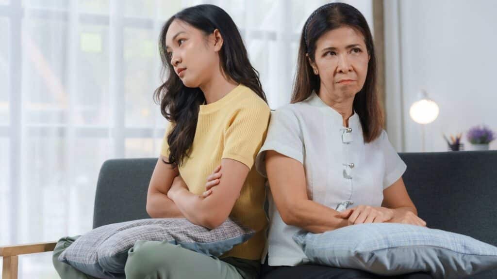 Mother and daughter looking angry at one another