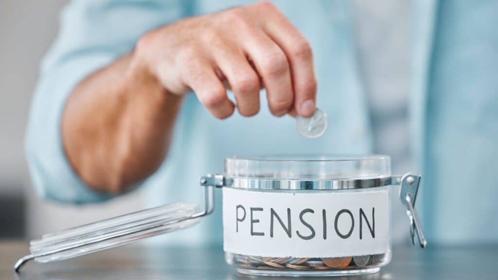 Man putting change into a jar labeled "pension"