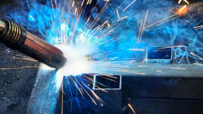 Person welding a piece of metal