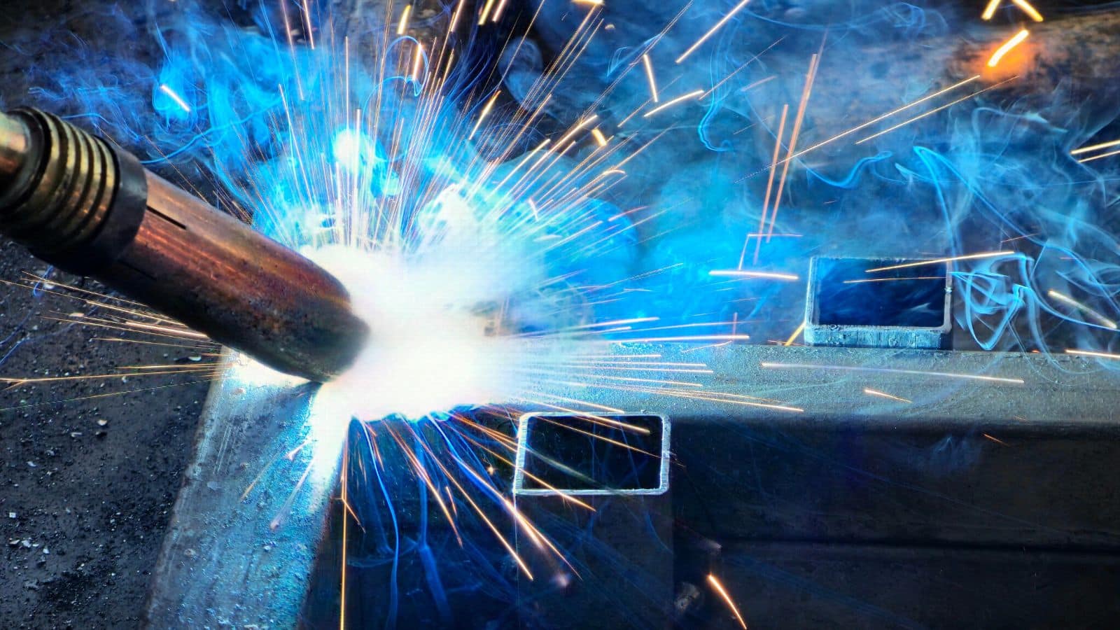Person welding a piece of metal