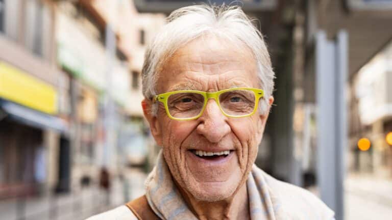Boomer man smiling and wearing yellow glasses