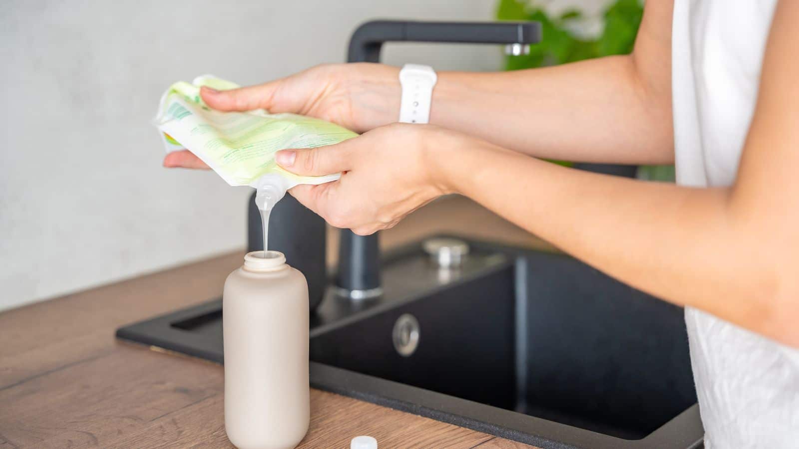 Woman refilling a bottle with soap