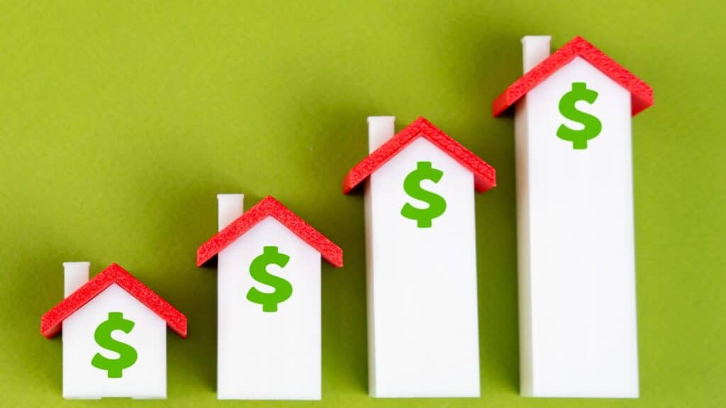 Little white houses with red roofs and dollar signs on them