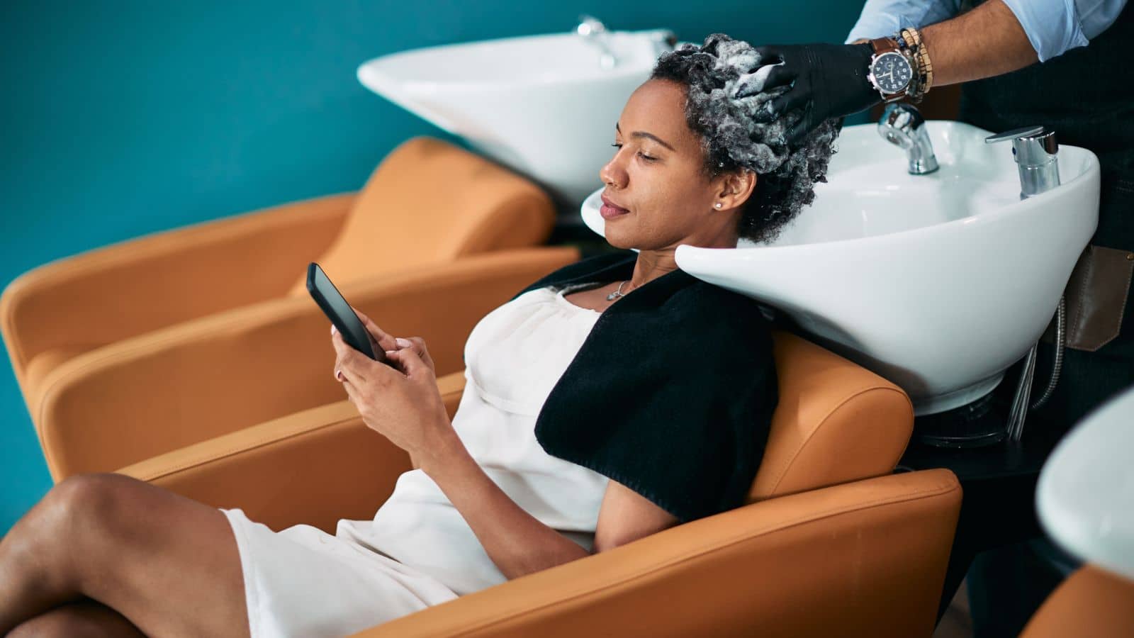 Woman getting her hair washed at a salon