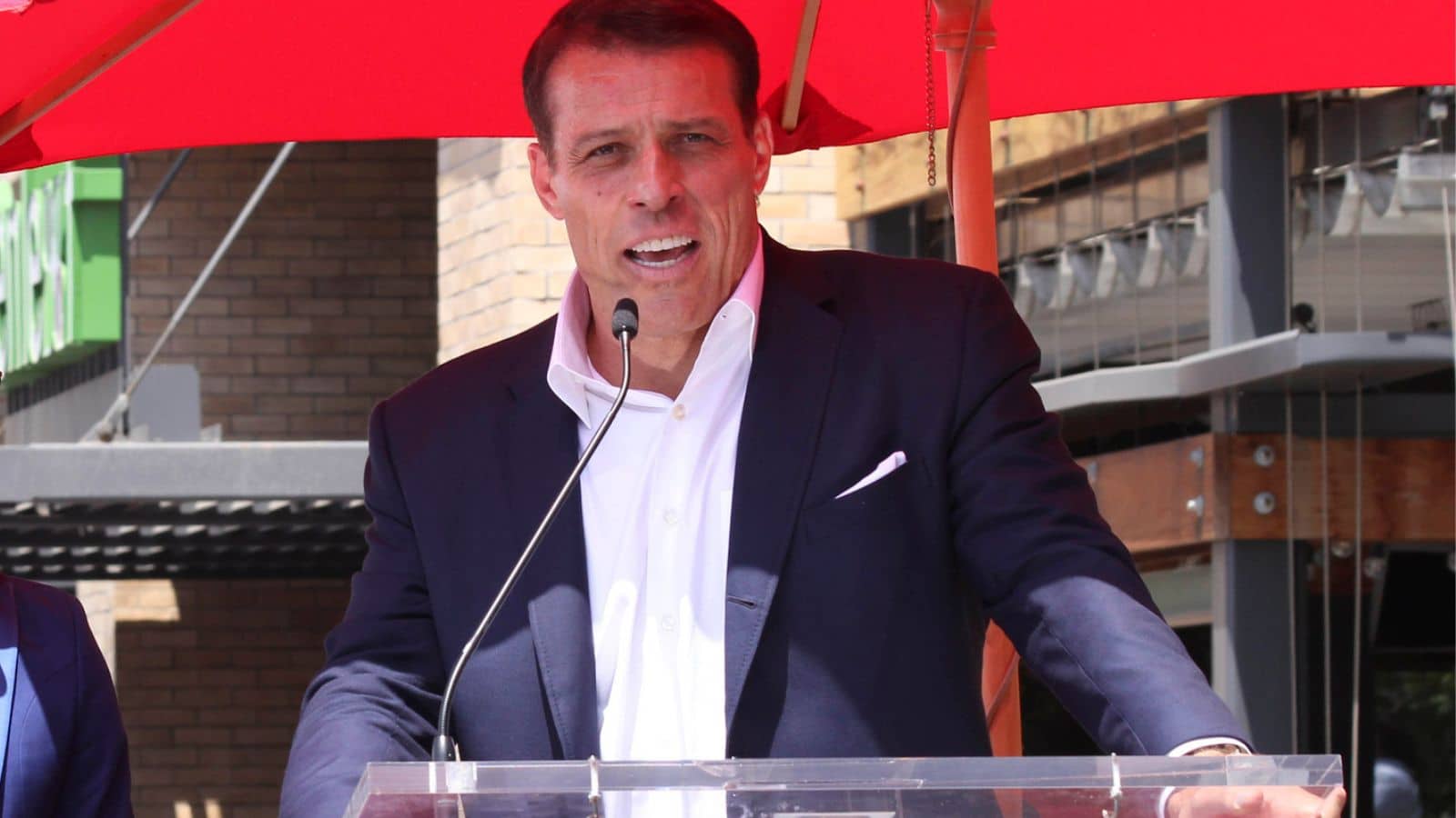 Tony Robbins speaking at a podium