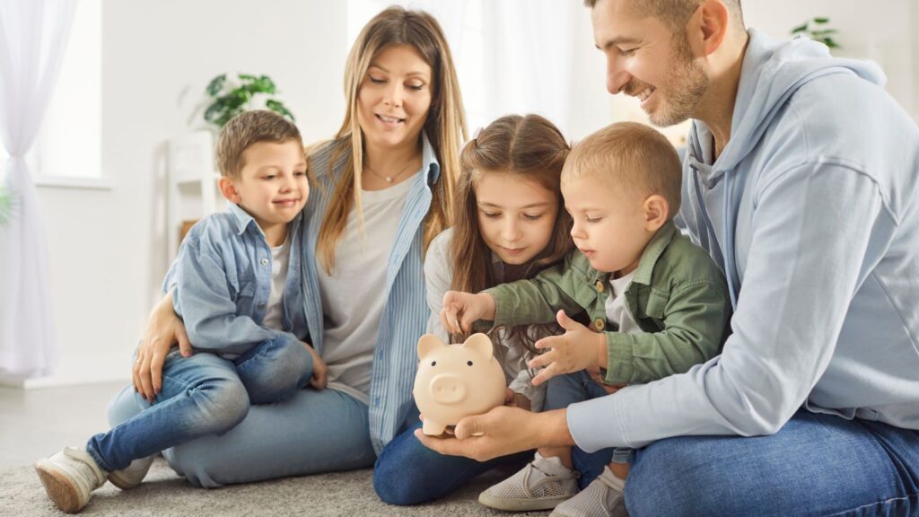 Family putting change in a piggy bank