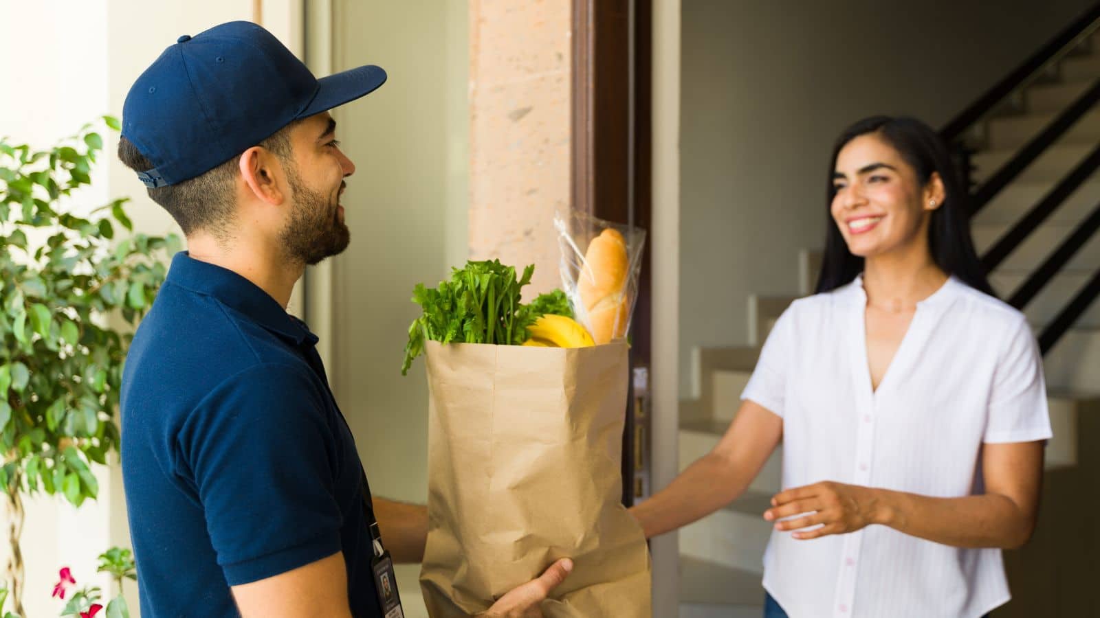Man delivering groceries to a woman