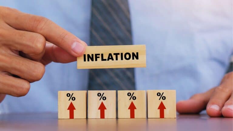 Man using wooden blocks that say 'inflation'