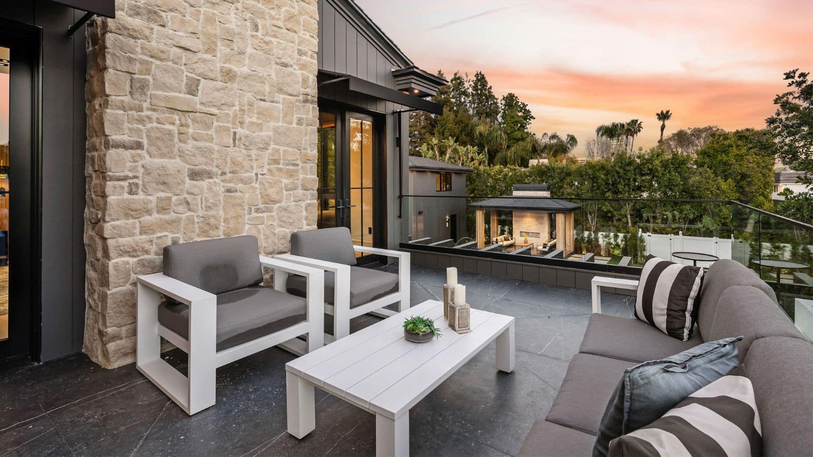 Back patio with furniture and a sunset