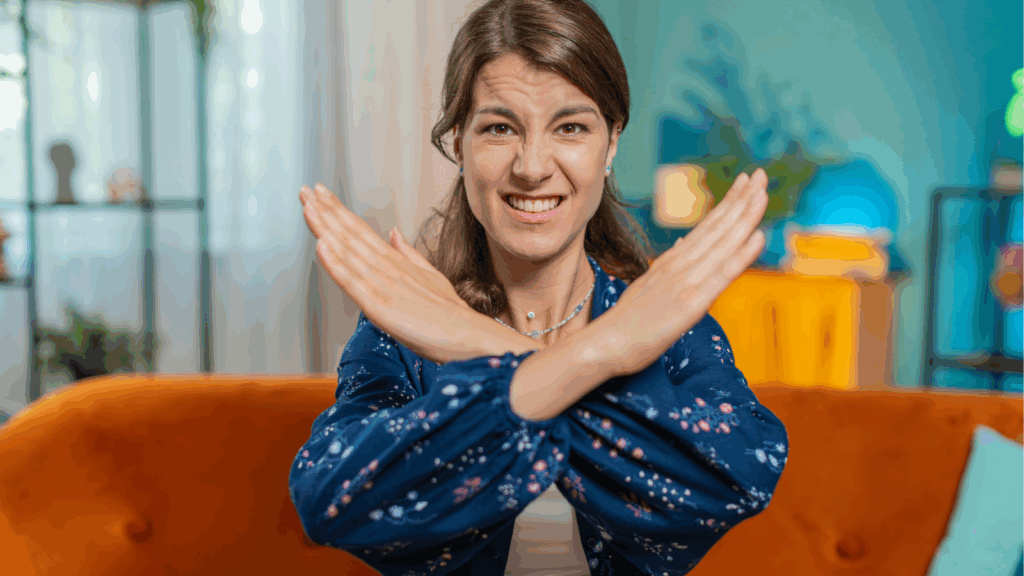 Woman crossing her arms in front of her to say "no"